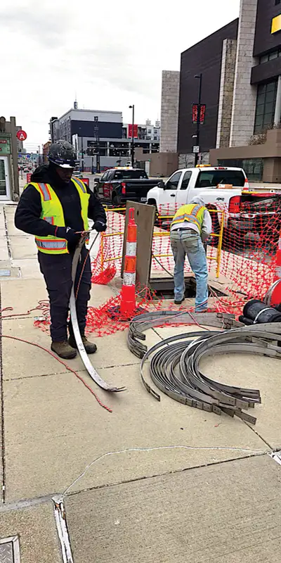 Technicians preparing to enter a pipe with all the HydraTite materials to repair the pipe joints below the road