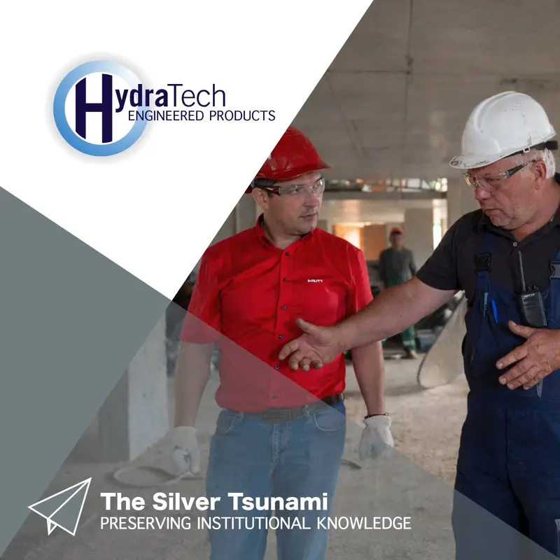 Two people wearing hard hats talking