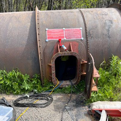 An entrance to a large penstock pipe