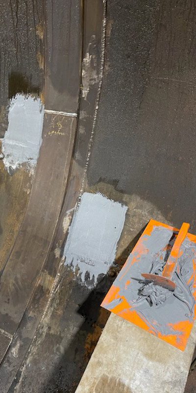 Portions of metal inside a penstock pipe coated in epoxy