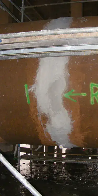 Cement patch applied over a joint's exterior on a large pipe