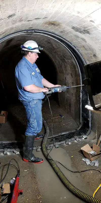 A technician installing HydraTite in an irregularly-shaped pipe