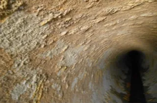 An internal view of a cooling water piping with corrosion.