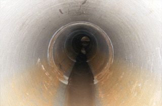 A long dark section of a sewer pipeline
