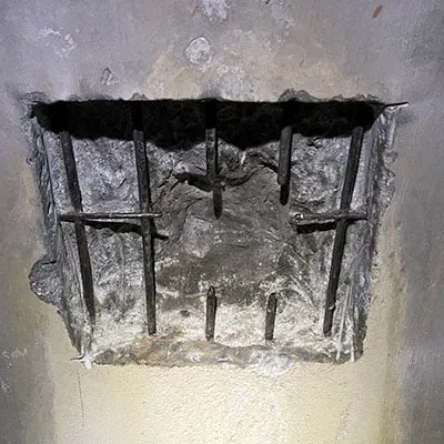 A portion of concrete removed from the interior wall of a pipe