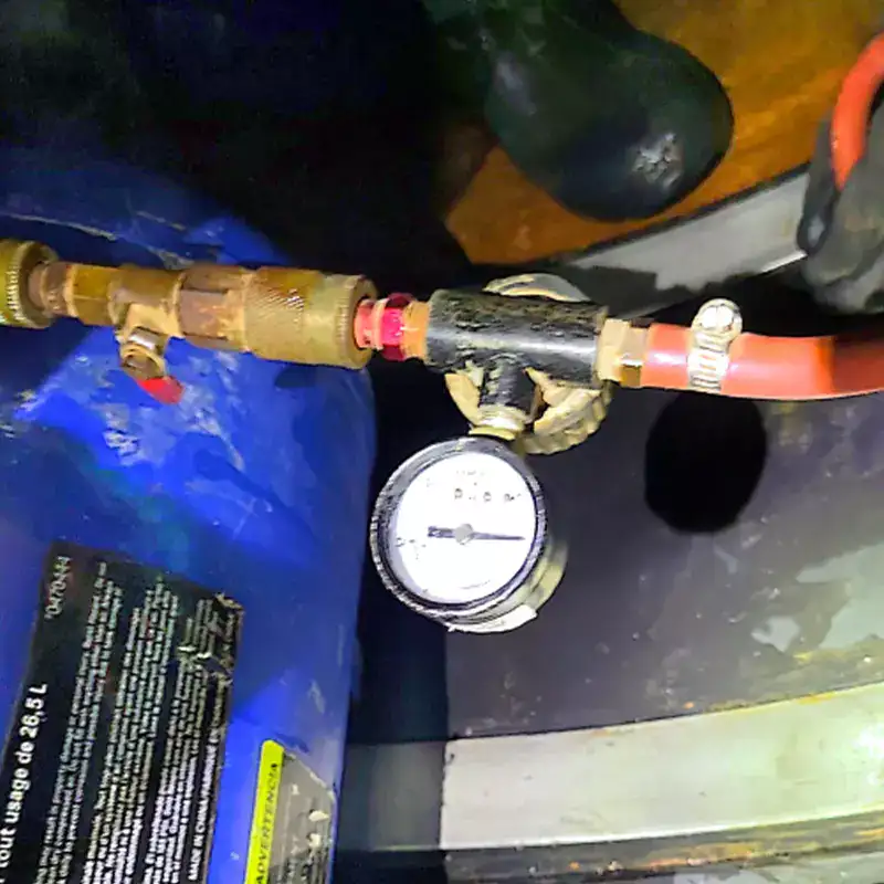 An air pump and a gauge being used to air test a HydraTite seal installation