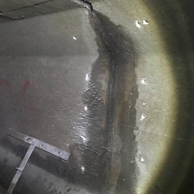 Anchor holes drilled on either side of a box-shaped culvert joint