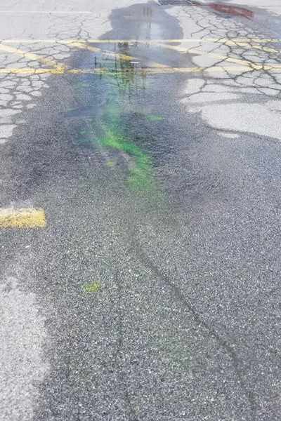 A puddle in a parking lot of a power station