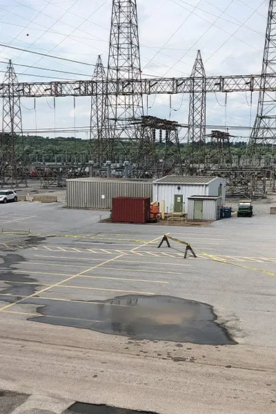 A puddle in a parking lot of a power station
