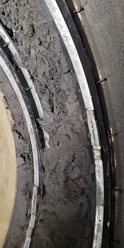 Concrete packed into a pipe joint to help transition a joint