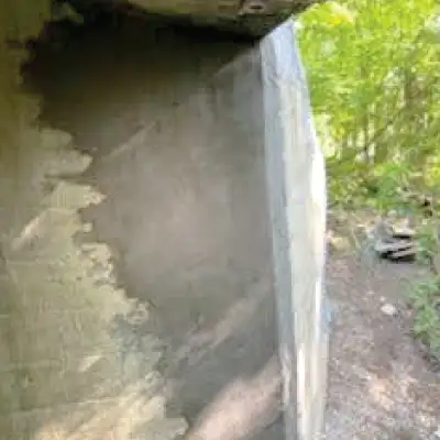 A patch of concrete applied to the interior of a culvert