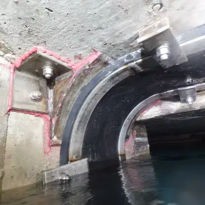 HydraTite installed over a joint in a box-shaped pipe that is nearly full of water