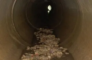 Debris littering the invert of this pipe