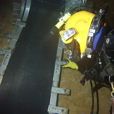 HydraTite being installed by a diver in a box-shaped chamber to prevent leaks