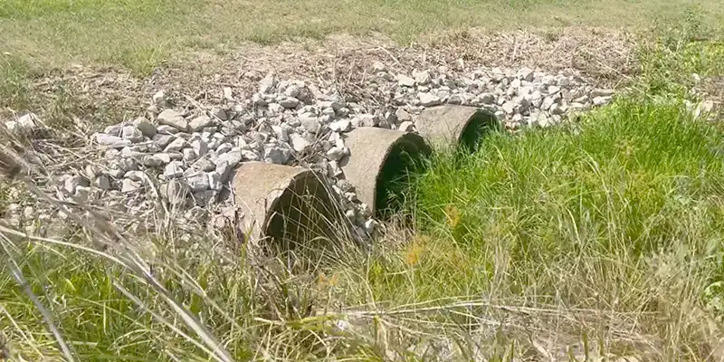 A triple culvert running below a road