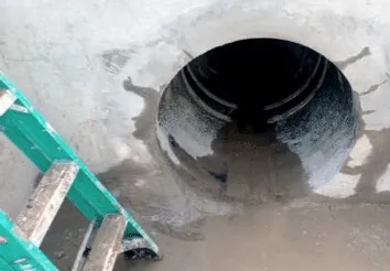 An opening to a 36 inch corrugated polyethylene outfall pipe, with HydraTite installed near the opening