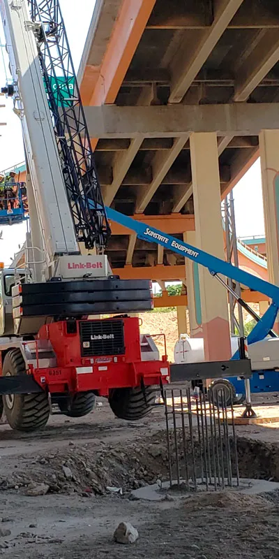 Several piece of equipment under a bridge