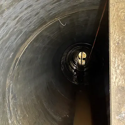Inside a long run of dark pipe