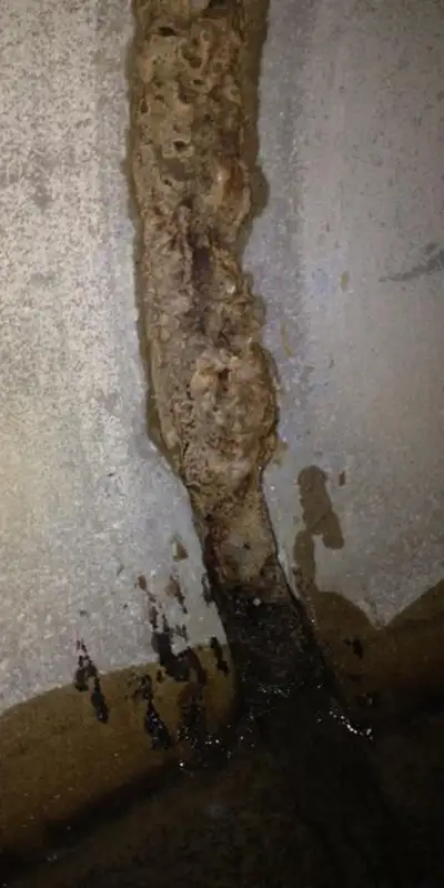 A separated joint inside a storm drain that has collected mineral build-up