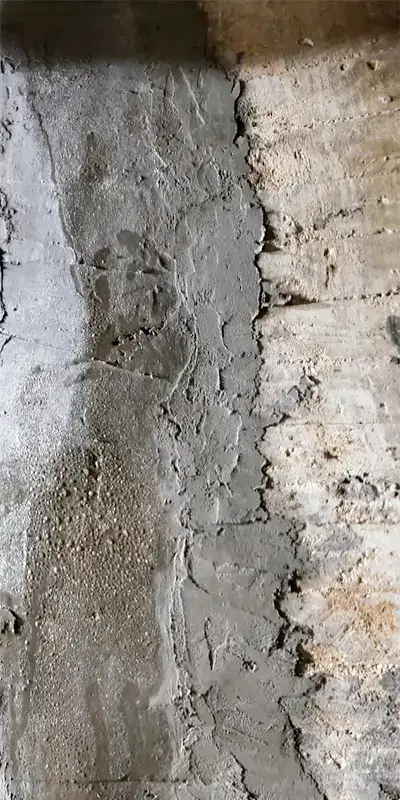 A jointed coated in grout inside an irregularly-shaped pipe