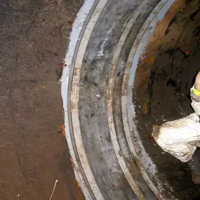A technician installing HydraTite over an expansion joint