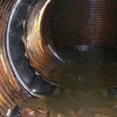 HydraTite Installed Over A Joint In A Corrugated Overflow Pipe