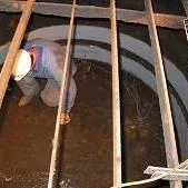 A technician working inside an expansion joint
