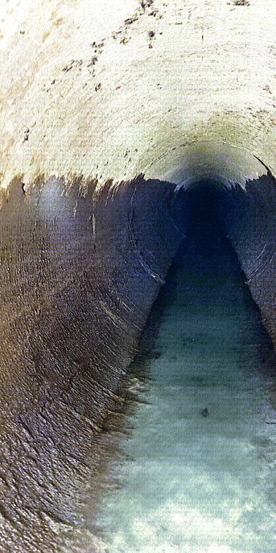An interior view of a long dark pipe
