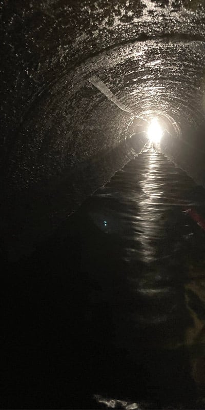 A long dark pipe with a light at the end