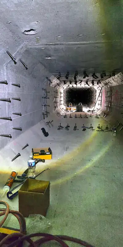 A long storm drain sump with anchors on either side of the joints