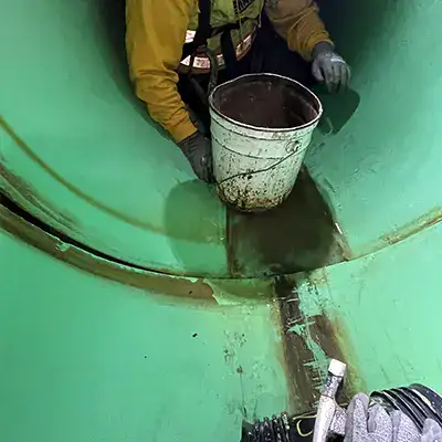Tools sitting inside a pipe near a pipe joint