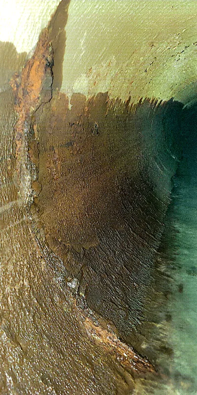 An interior view of a long dark pipe