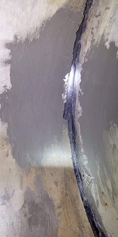 A patch of concrete inside a pipe near the joint