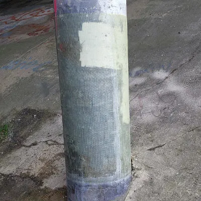 A column under a bridge being restored with a fiber composite wrap