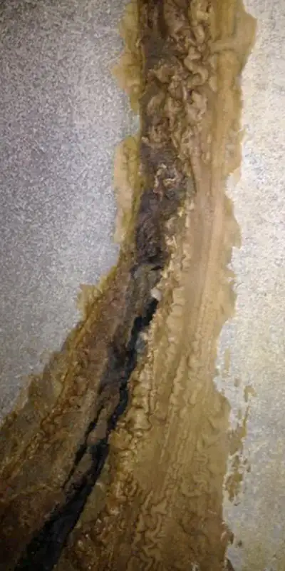 A separated joint inside a pipe that has collected mineral build-up