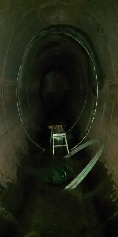 Steel bands sitting near a joint in an elliptical pipe