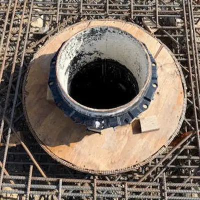 A vertical pipe opening at a construction site