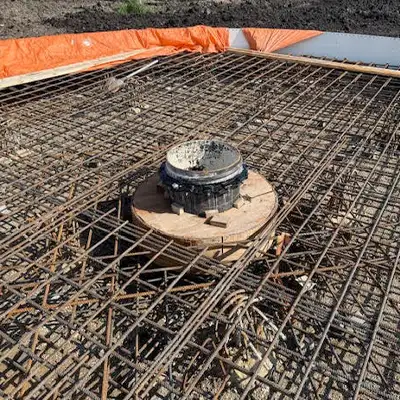 A vertical pipe opening at a construction site