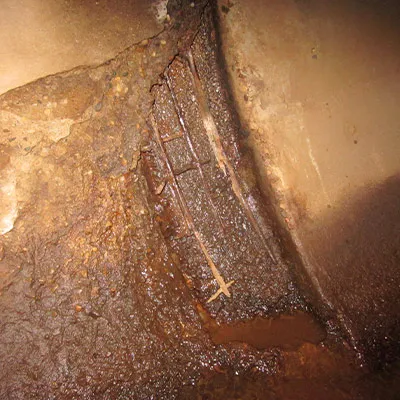 A portion of concrete spalling and exposed rebar