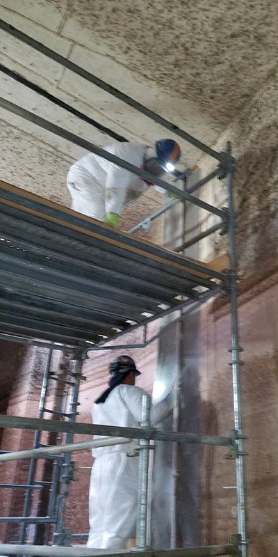 Technicians working on the inside of an expansion
