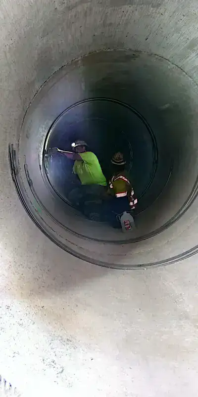 A technician preparing to install HydraTite over a pipe joint