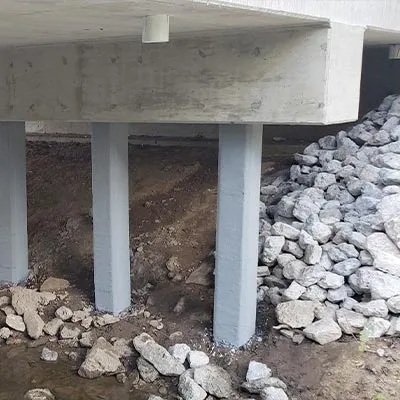 Glass fiber wrap, and a cementitious coating applied to spalling concrete to restore them