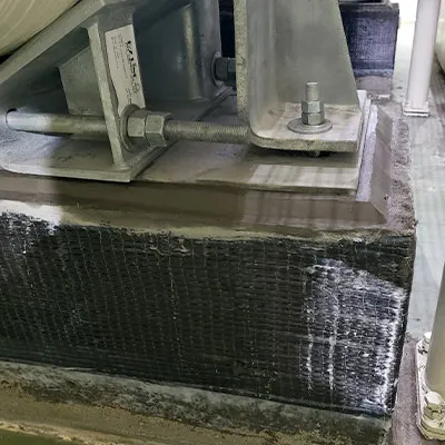 Piers under a tank wrapped in a carbon fiber reinforced composite