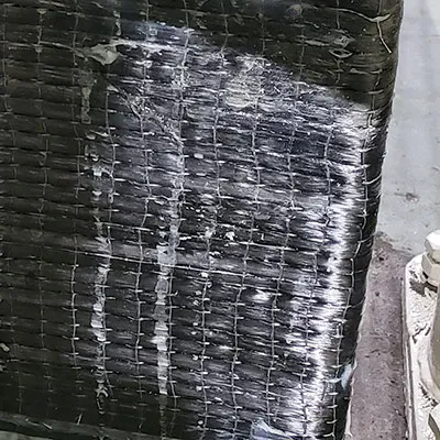 Piers under a tank wrapped in a carbon fiber reinforced composite