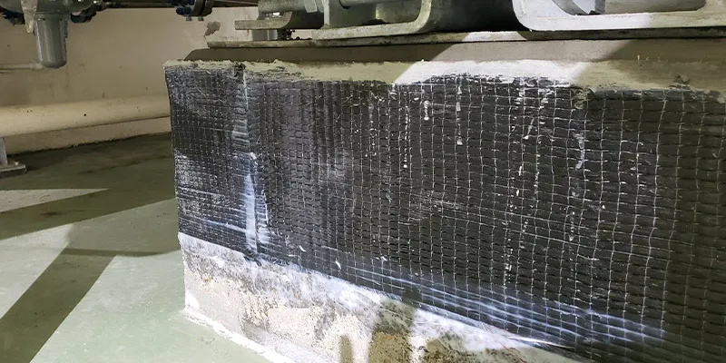 Piers under a tank wrapped in a carbon fiber reinforced composite