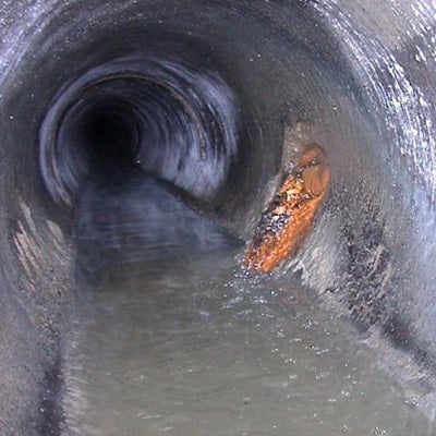 A sewer pipe with severely damaged portions