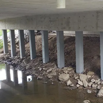 Glass fiber wrap, and a cementitious coating applied to spalling concrete to restore them