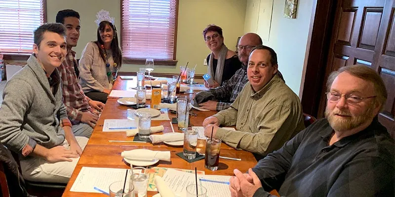A group of HydraTech employees sitting together for the yearly Christmas lunch