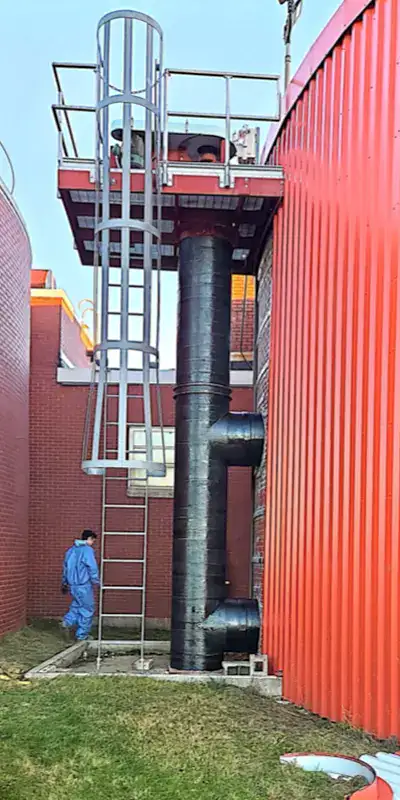 HydraWrap applied to a vertical digester mixing pipe to fortifying it against corrosion