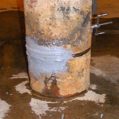Epoxy atop a clamp on a compromised ash sluice pump intake manifolds